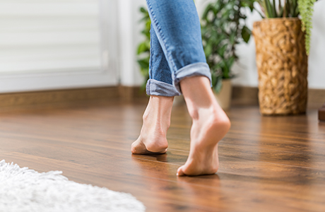 a lady walking barefoot on a underfloor heated room